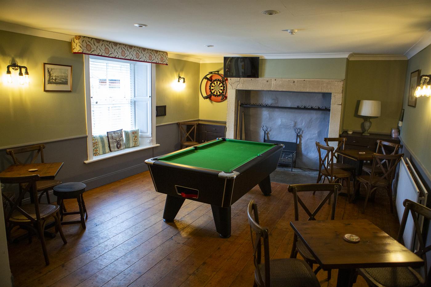 The sports room with a pool table and dartboard