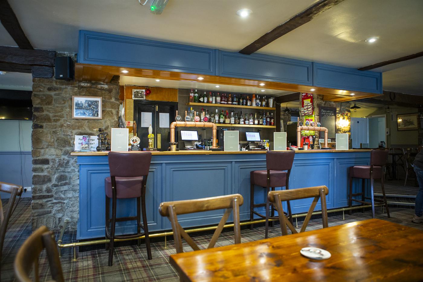 The blue-panelled bar with bar stools