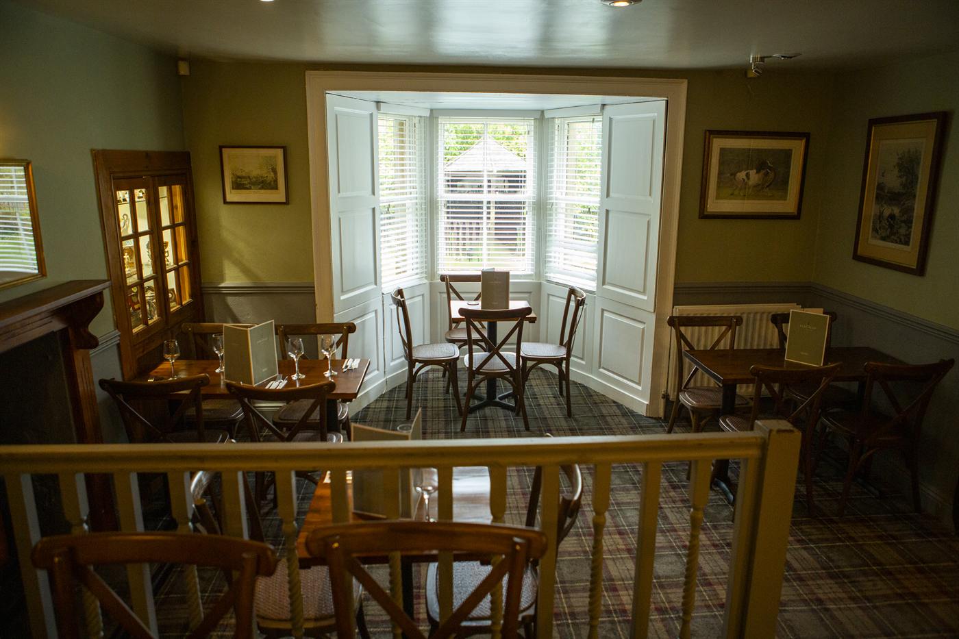 Dining room with a bay window and wooden tables