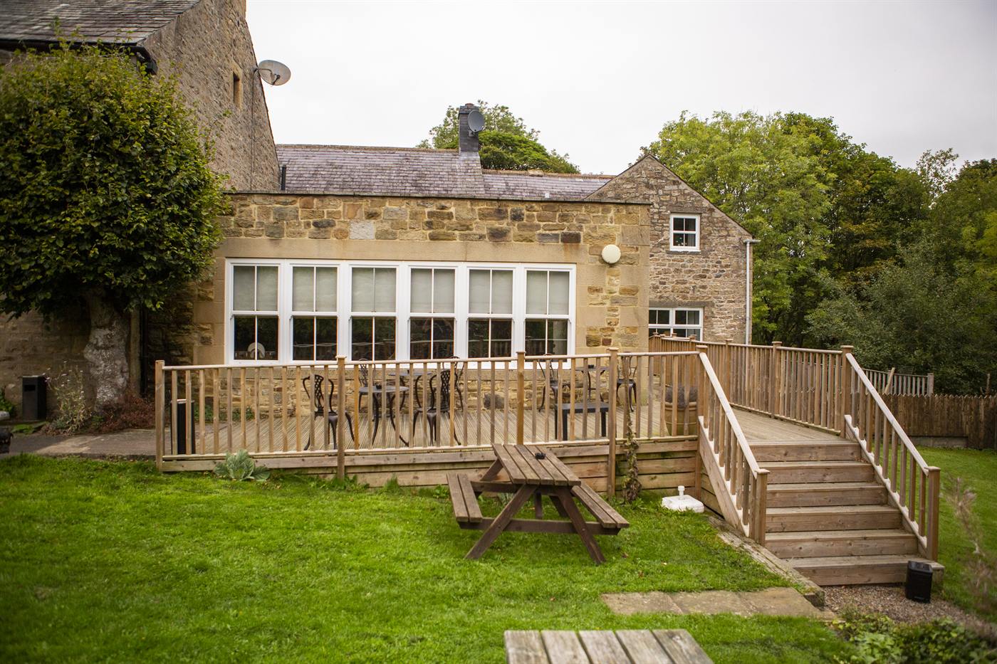 The back of the inn with decking over the lawn
