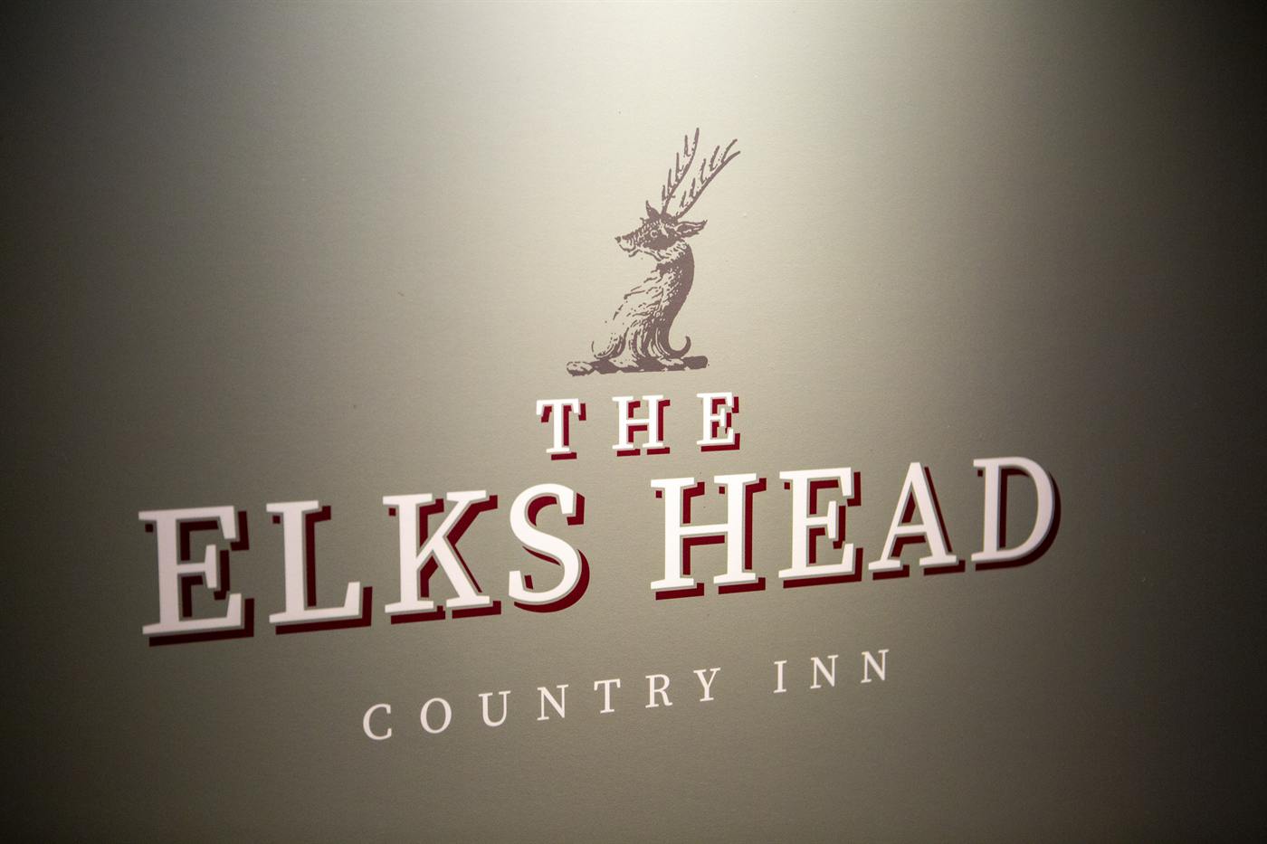 The Elks Head Country Inn sign painted on the wall