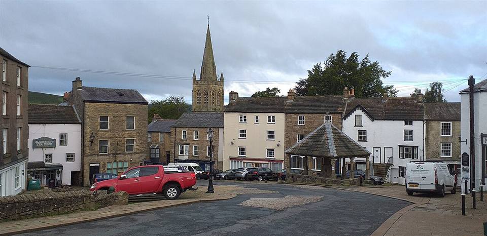 Stone buildings on the steep cobbled Front Street in Alston